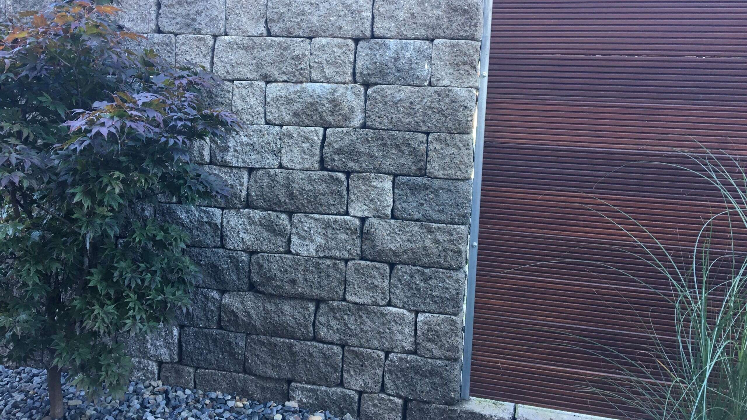 Mauer mit Zaunelement im Garten